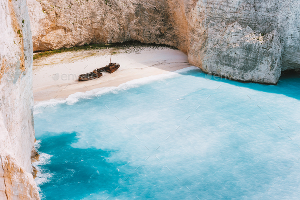 Navagio beach with turquoise blue sea water surrounded by huge white limestone cliffs. Famous - Stock Photo - Images