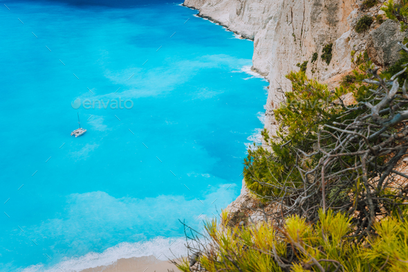 Lonely catamaran yacht in blue bay of Navagio beach. Azure turquoise sea water pattern near paradise - Stock Photo - Images