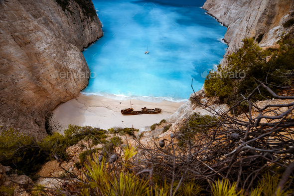 Shipwreck in Navagio beach. Azure turquoise sea water surrounded by huge rocks. Famous tourist - Stock Photo - Images