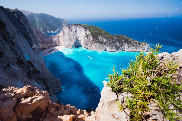 Navagio beach or Shipwreck bay. Turquoise water and pebble white beach in morning light. Famous - Stock Photo - Images