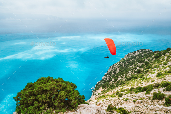 Paraglider flying at Myrtos beach. Kefalonia island, Greece. Recreation hobby activity