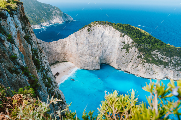 Navagio beach or Shipwreck bay. Turquoise water and pebble white beach in morning light. Famous - Stock Photo - Images