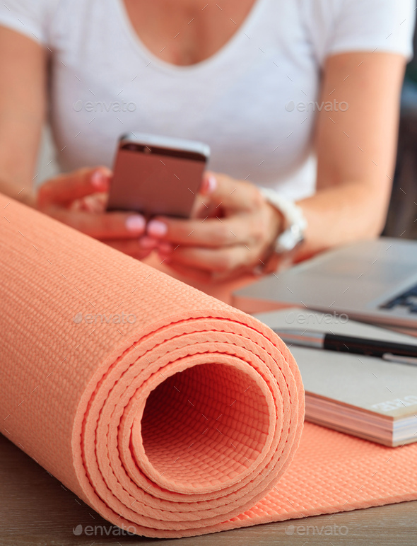 Woman and an exercise mat, corporate office background