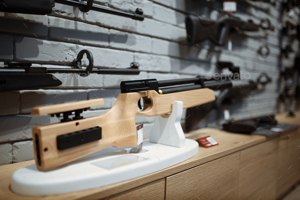 Pneumatic rifles on showcase in gun shop closeup