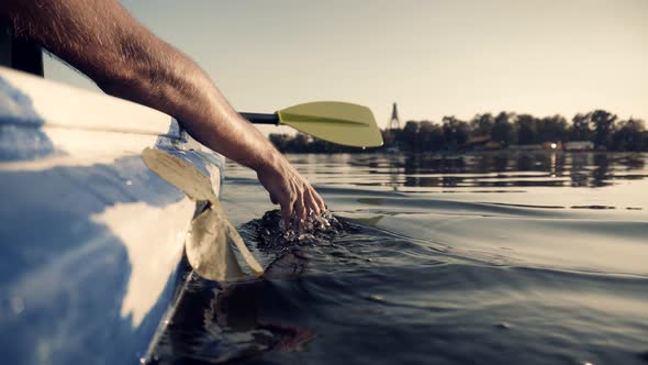 Close Up Man Hand Splashing Water Enjoying Touching Waves Sliding  With Fingers On Surface Summer. alt