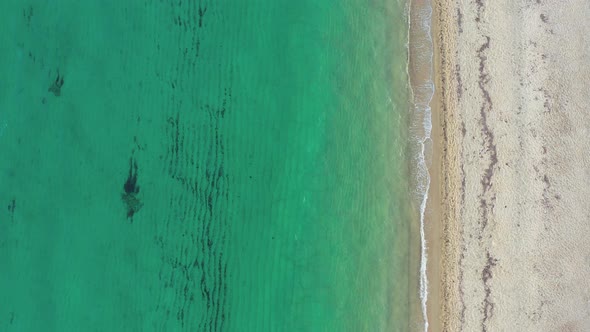Aerial view of sea and sand beach on a sunny day. alt