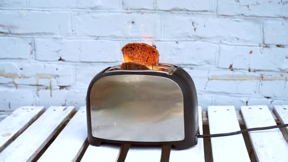 Burning Toaster with Two Slices of Toast Caught on Fire