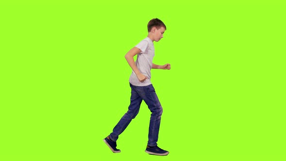 Teenage Boy Running in White T-shirt and Jeans