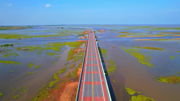 Drone video of the road leads through a large beautiful wetland. alt