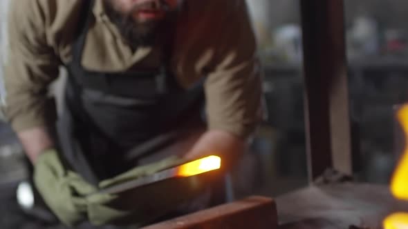 Blacksmith Melting Billet in Coals alt