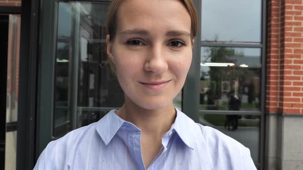 Camera View of Woman Taking Selfie on Phone alt