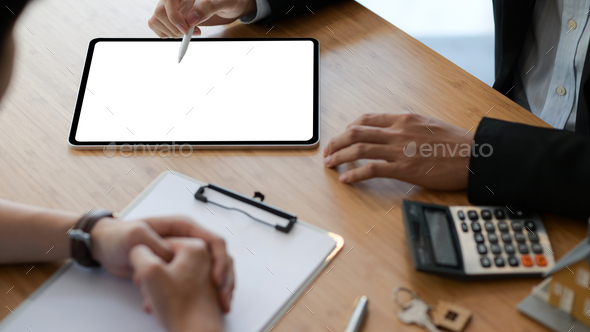 Real estate insurance agents are using tablet to recommend insurance packages to customer. - Stock Photo - Images