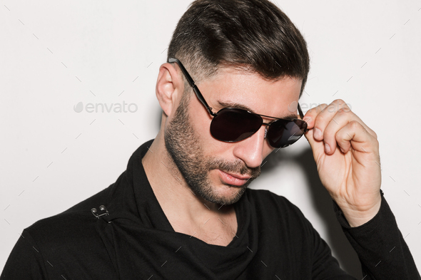 Fashion Portrait Of Young Sexy Man Wearing Shirt And Sunglasses Poses On  Gray Background Stock Photo, Picture and Royalty Free Image. Image 24459876.