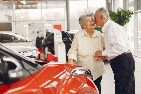 Elegant old couple in a car salon