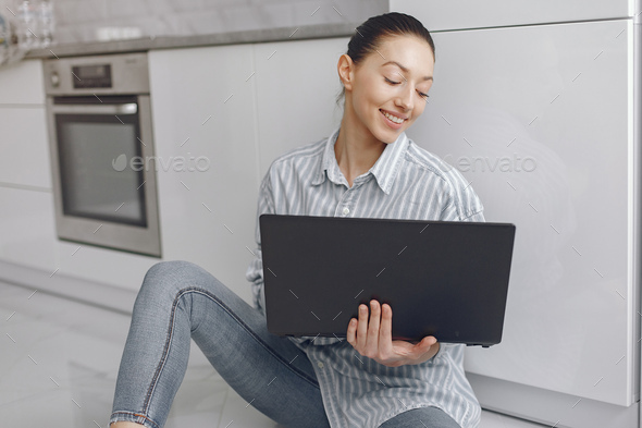 Girl sitting at home and use the laptop