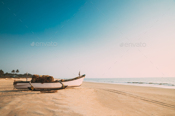 Goa, India. Old Wooden Fishing Boat Standing On Sea Ocean Beach. Tropical  Palms On Background Stock Photo by Grigory_bruev