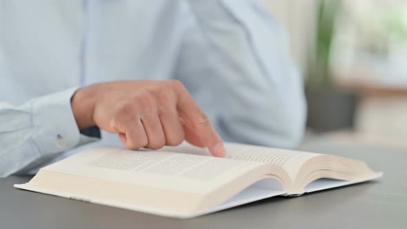 African Man Reading Book Close Up alt