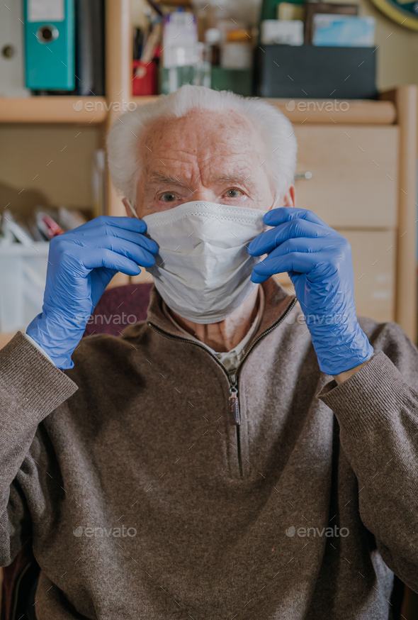 Old man wearing protective mask and gloves