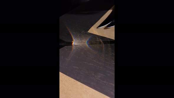 Vertical video of moving light and shadows on tabletop
