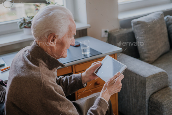 Positive Senior using Digital Tablet - Stock Photo - Images