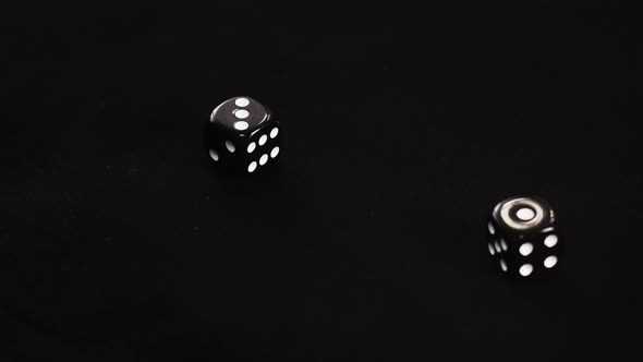 Gamer Hand Throwing Black Double Dice on Dark Background. Rolling Dice in Night Casino. Close Up alt