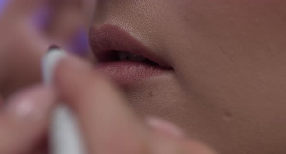 Girl Paints Her Lips With Lipstick Closeup