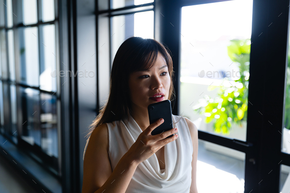 Asian woman talking to her phone