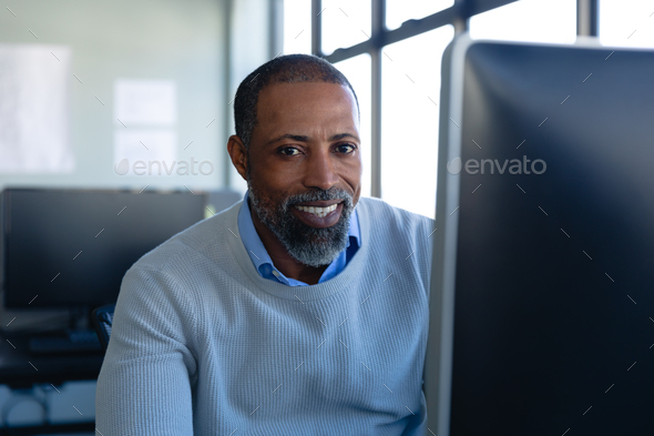African American man in office looking at camera