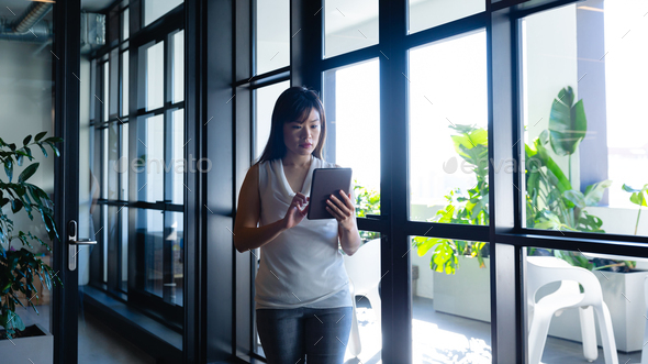 Asian woman using a digital tablet