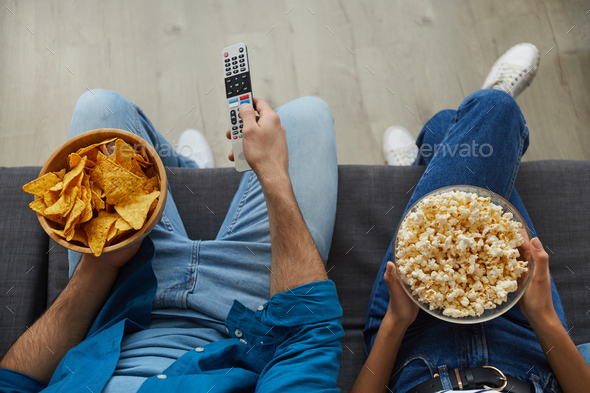 Couple Watching TV with Snacks Top View