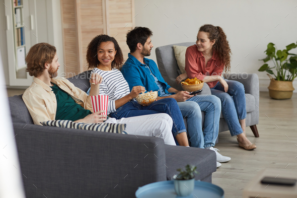 Multi Ethnic Group of Friends Watching TV at Home