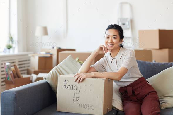 Smiling Asian Woman Ready to Move