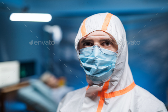 Man with protective suit and face mask indoors, coronavirus concept
