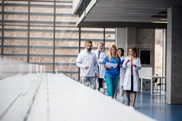 Group of doctors walking in corridor on medical conference