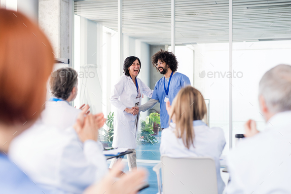 Group of doctors on medical conference, shaking hands