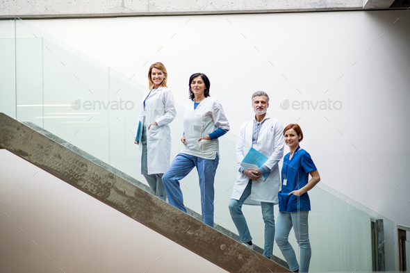 Group of doctors standing on stairs on medical conference