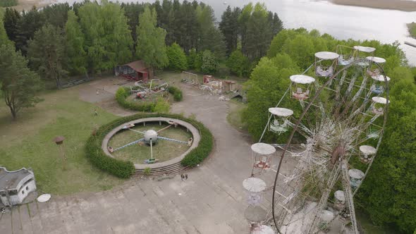 Abandoned and Forgotten Amusement Park With Swings and Carousel alt