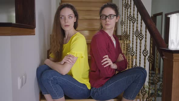 Argued Slim Beautiful Identical Women Sitting Back to Back on Stairs Thinking Sighing alt