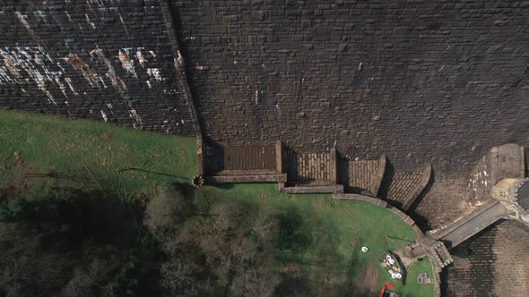 Top down aerial view rising above Scar house reservoir infrastructure high angle view overlooking da alt