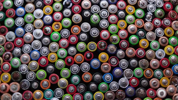 Used Batteries are Stacked in the Center Types AAA AA 9Volt Top View Background alt