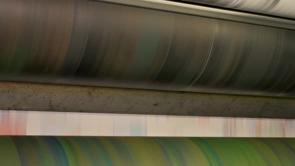 Ink rollers at high speed in a printing factory printing newspapers alt