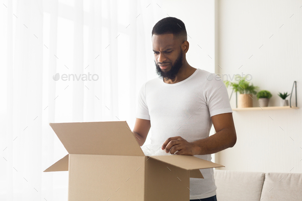 Sad african american millennial guy received wrong order