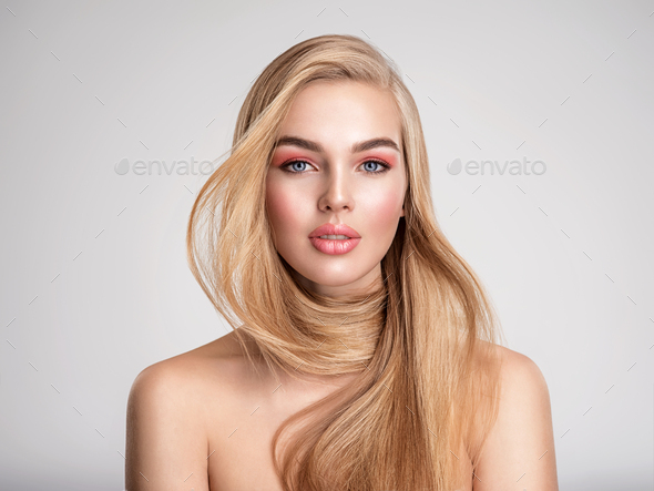 Portrait of a blonde beautiful woman with a long straight light hair.