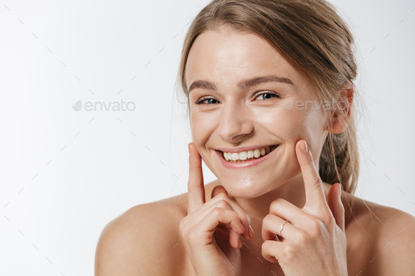 Portrait of a smiling young woman washing dishes Stock Photo by vadymvdrobot