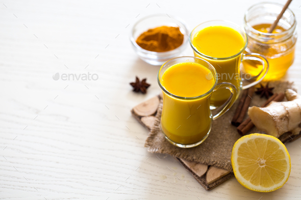 Turmeric tea drinks with milk and honey for beauty and health