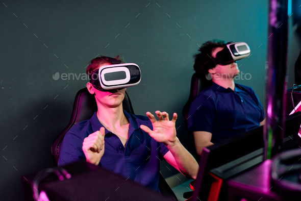 Young men using virtual reality simulators