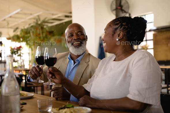 African man and woman drinking wine