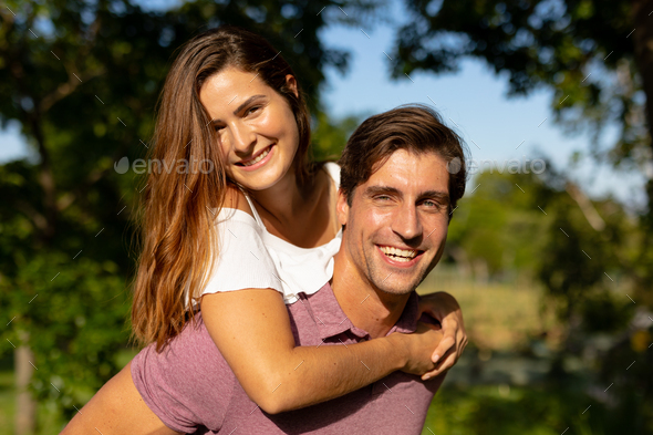 Happy young couple holding each other in the garden
