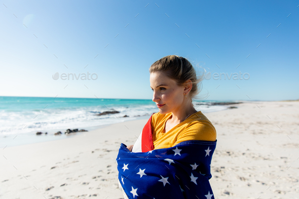 Woman with american flag at the beach