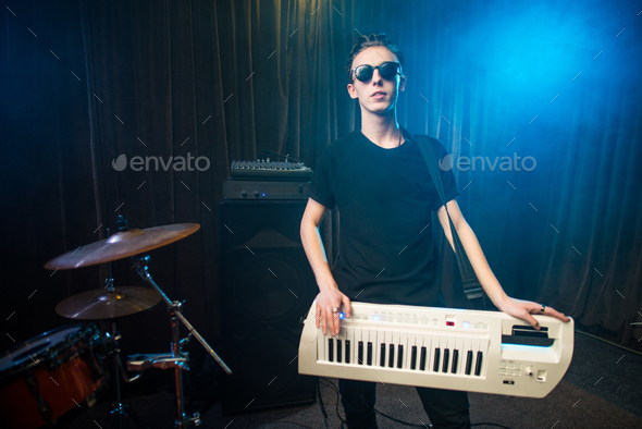 Man in sunglasses playing on electronic keyboard - Stock Photo - Images